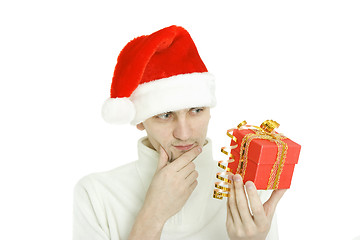 Image showing The thoughtful man with gift in hand