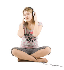 Image showing The girl listens to music