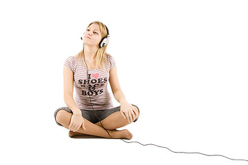 Image showing The girl listens to music