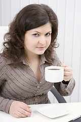 Image showing The business woman drinks coffee