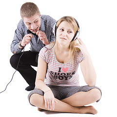 Image showing Playful family scene with ear-phones