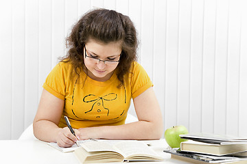 Image showing The girl the student with writing-books and books