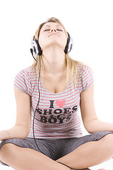 Image showing The girl listens to music