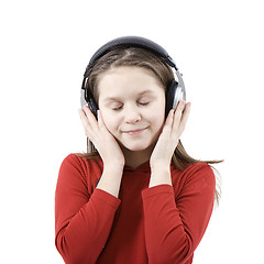 Image showing The child listens to music