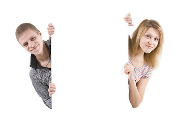 Image showing Happy man and the woman behind the white stand