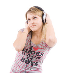 Image showing The girl listens to music