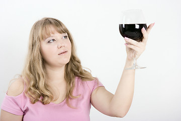 Image showing The young woman with a wine glass