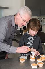 Image showing Decorating the cupcakes