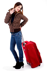 Image showing young lady posing with luggage