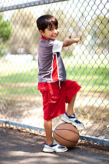 Image showing Smart kid posing with basketball