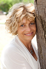 Image showing Image of Portrait of a happy senior woman holding tree