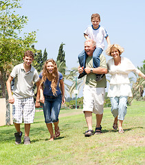 Image showing happy family running towards camera