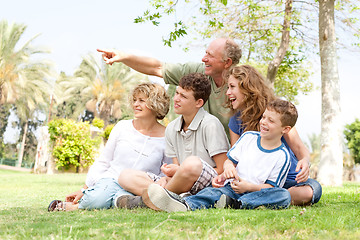 Image showing potrait of grandfather pointing with family