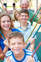 Image showing image of Portrait of a happy family swinging in a line