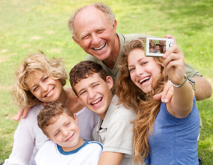 Image showing Family outdoors taking self portrait