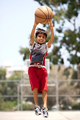 Image showing Young basketball player jumping high