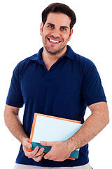 Image showing young man holding notepad