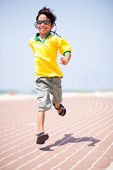Image showing Young kid running on race track