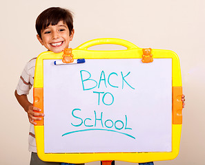 Image showing Little boy smiling with a whitebaord