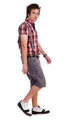 Image showing Casual young guy in walking posture