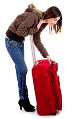 Image showing young woman searching her baggage