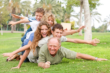 Image showing happy family laying on each other