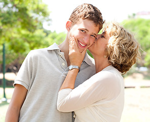 Image showing Image of Portrait of a happy senior woman kissing grandson