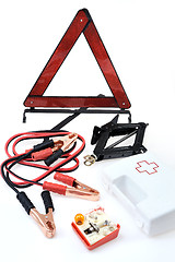 Image showing Emergency kit for car - first aid kit, car jack, jumper cables, warning triangle, light bulb kit