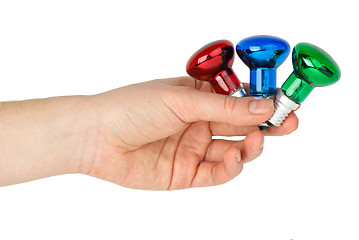 Image showing Hand hold tiny red, blue and green spot tungsten lightbulbs