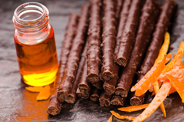 Image showing chocolate sticks with orange