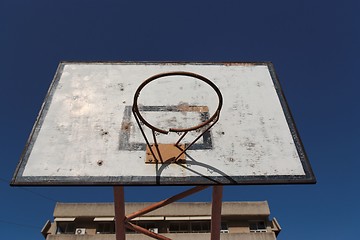 Image showing Old broken basketball hoop against the blue sky