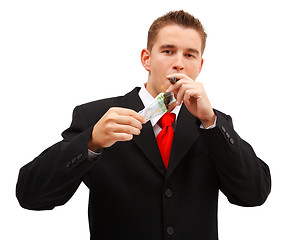 Image showing Rich business man lighting cigar