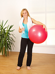 Image showing Woman holding big red ball