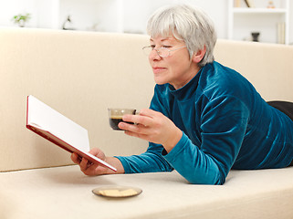 Image showing Senior woman with book and coffee