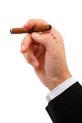 Image showing Hand holding burning cigar