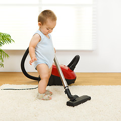 Image showing Baby boy with vacuum cleaner