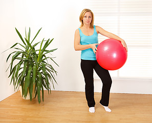 Image showing Woman holding big red ball