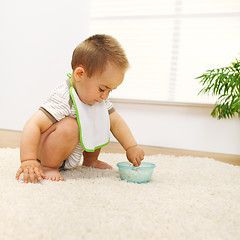 Image showing Baby boy playing with food