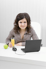 Image showing The business smiling girl with the laptop