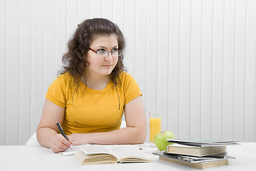 Image showing The girl the student with writing-books and books