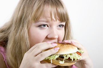 Image showing The young woman and hamburger