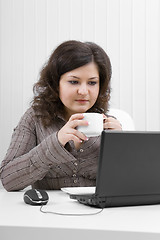 Image showing The business woman drinks coffee