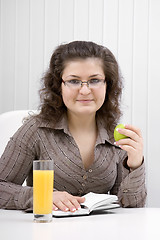 Image showing business woman with a notebook and an apple