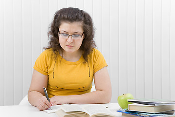 Image showing The girl the student with writing-books and books