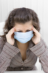 Image showing The sick girl with medical mask with sad eyes