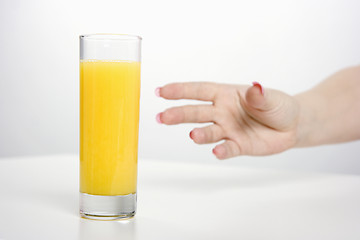 Image showing hand and a glass of juice