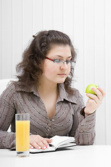 Image showing business woman with a notebook and an apple