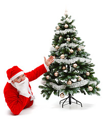 Image showing Santa Claus laying and showing decorated christmas tree