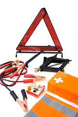 Image showing Emergency kit for car - first aid kit, car jack, jumper cables, warning triangle, light bulb kit