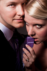 Image showing Beautiful young bride holding her groom on a leash